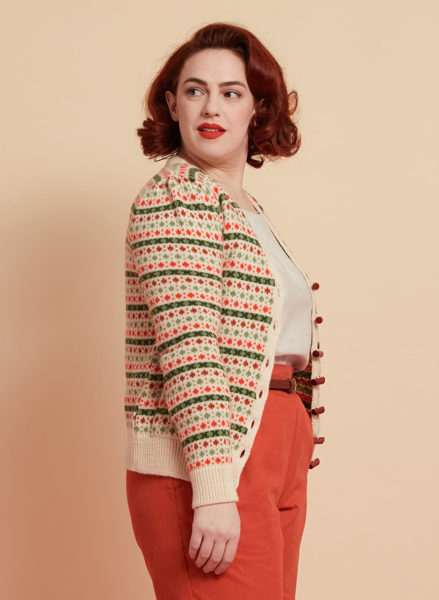 green and red striped vintage-style geometric knit cardigan made in the UK from 100% british wool, with slightly puffed sleeves and wooden buttons