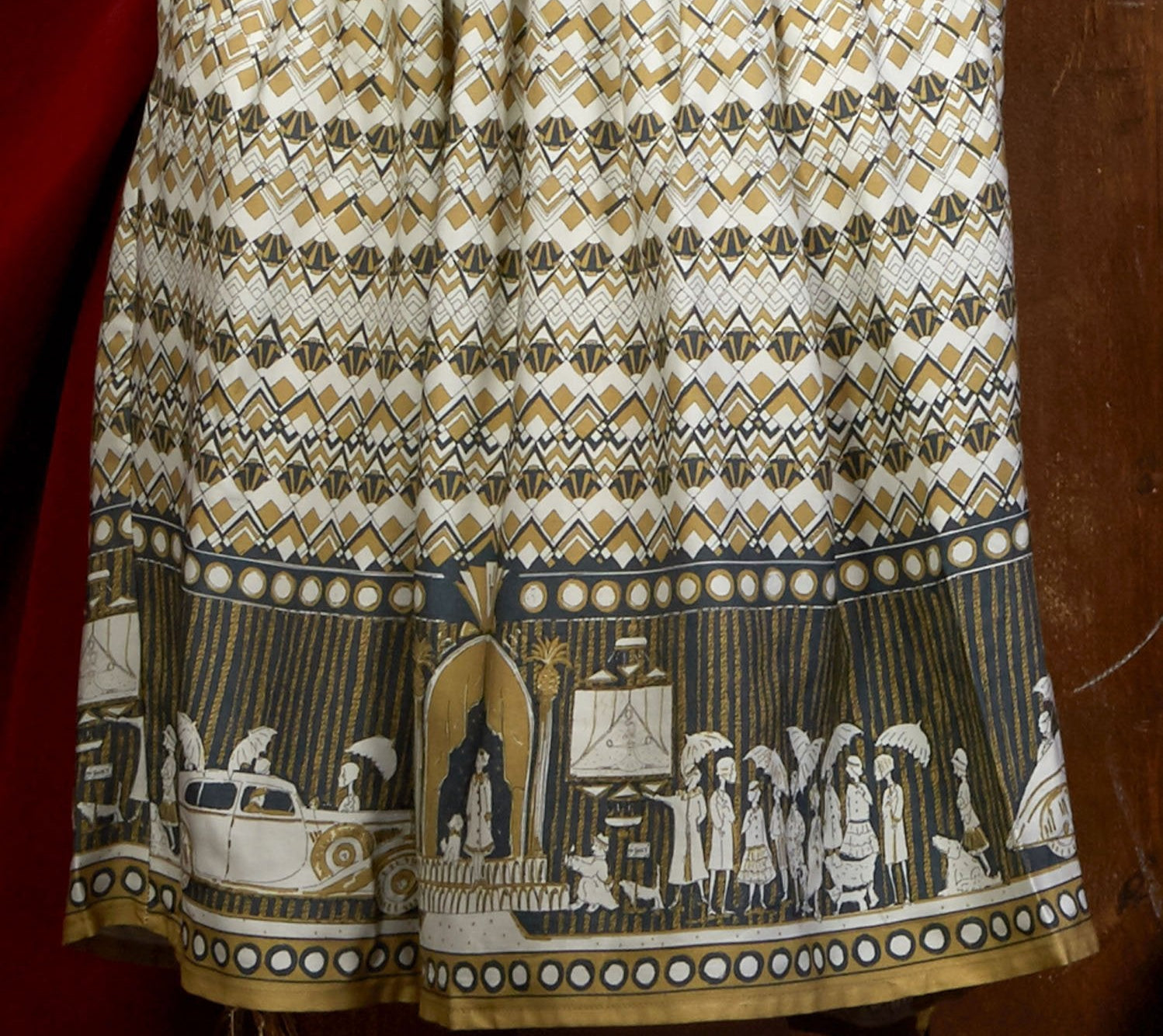 100% Tencel Lyocell vintage-style cream knee-length belted shirt dress with 3/4 length sleeves, pockets, and a moving pictures print inspired by the cinema.